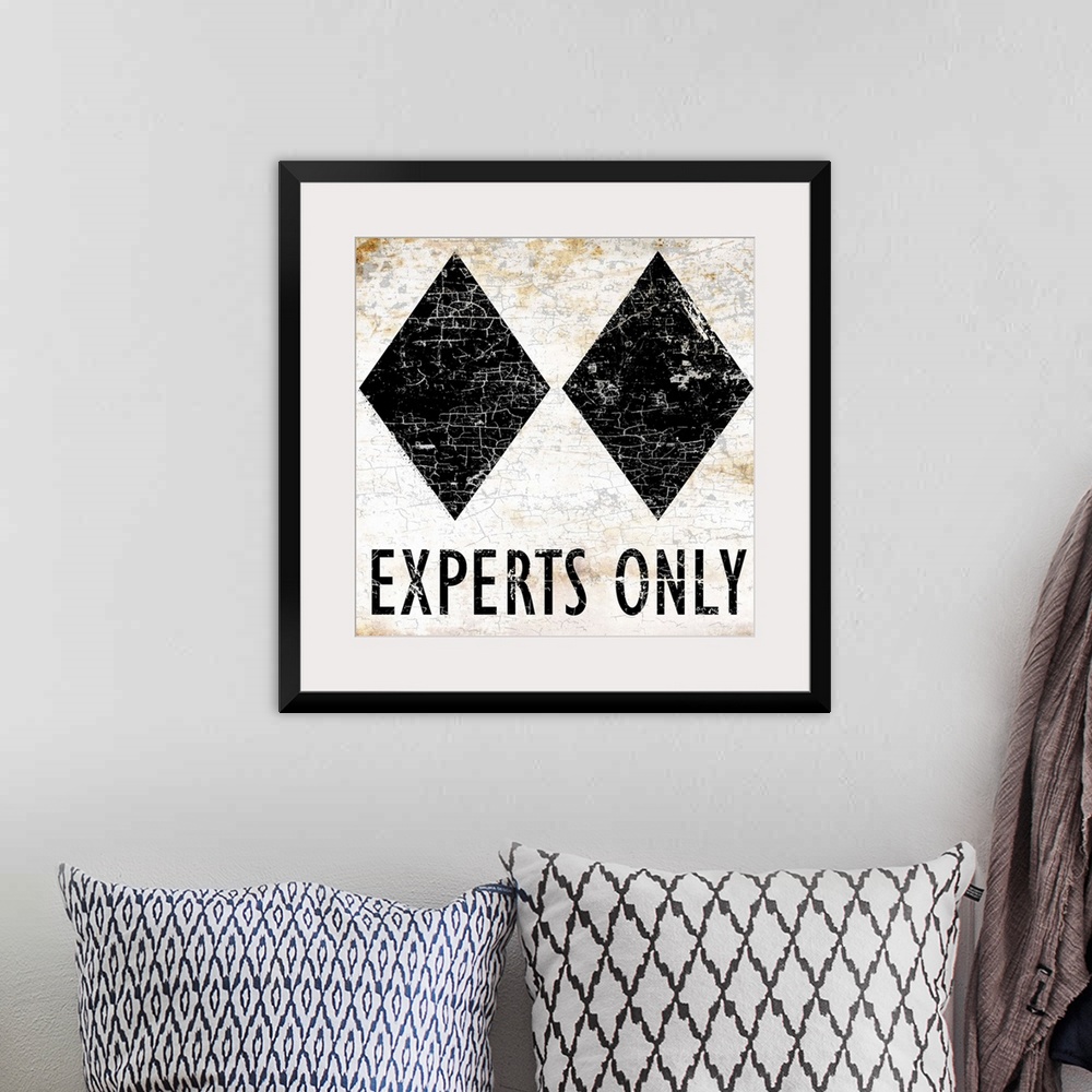 A bohemian room featuring A worn, distressed, cracked and rusty Experts Only ski sign.