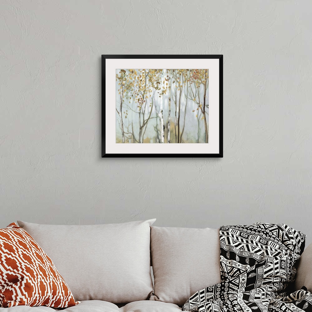 A bohemian room featuring Large landscape painting of birch trees in the woods with gold and red leaves.