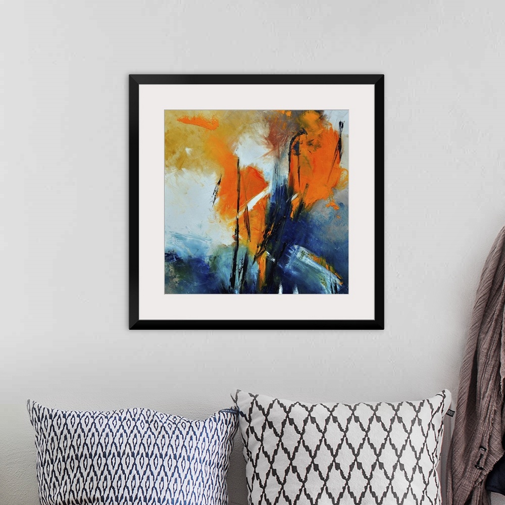 A bohemian room featuring A square abstract painting with deep textured colors of orange and blue.