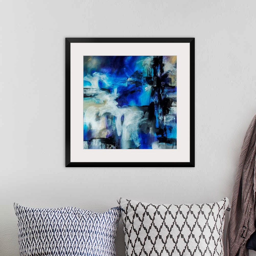 A bohemian room featuring Abstract artwork painted with bright blue tones underneath thick black and white brushstrokes.