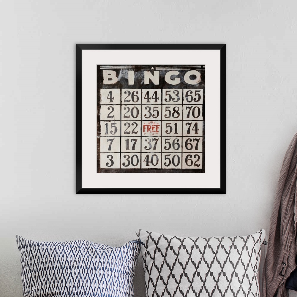 A bohemian room featuring This large piece has an antique style Bingo card that takes up the entire face of artwork.