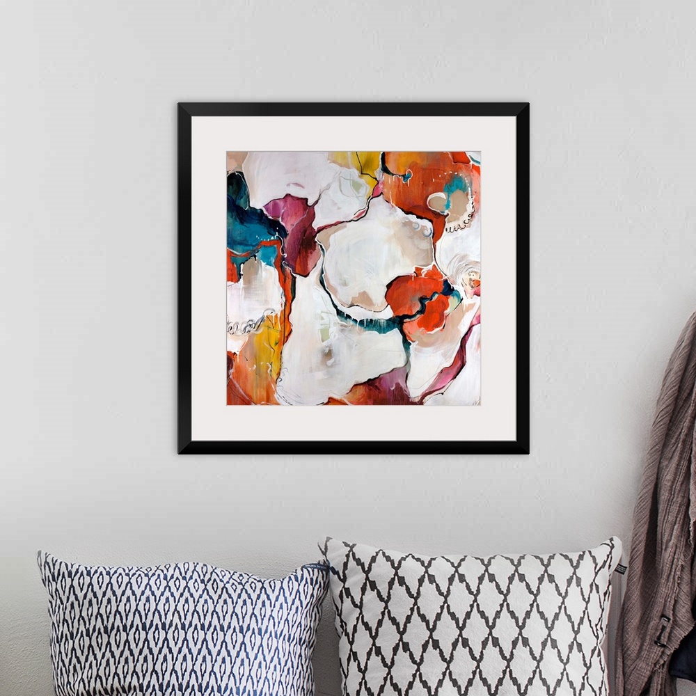 A bohemian room featuring A colorful piece of square artwork that is abstract with creamy paint textures.