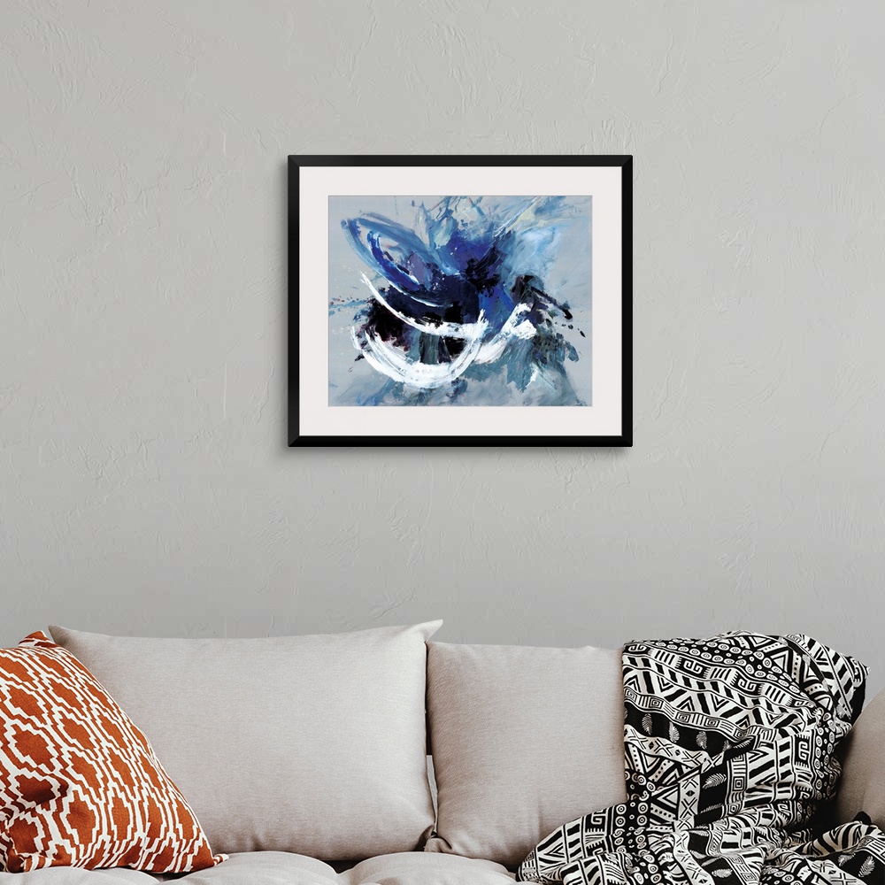 A bohemian room featuring Contemporary abstract artwork in blue, black, and white in broad, fast brushstrokes.