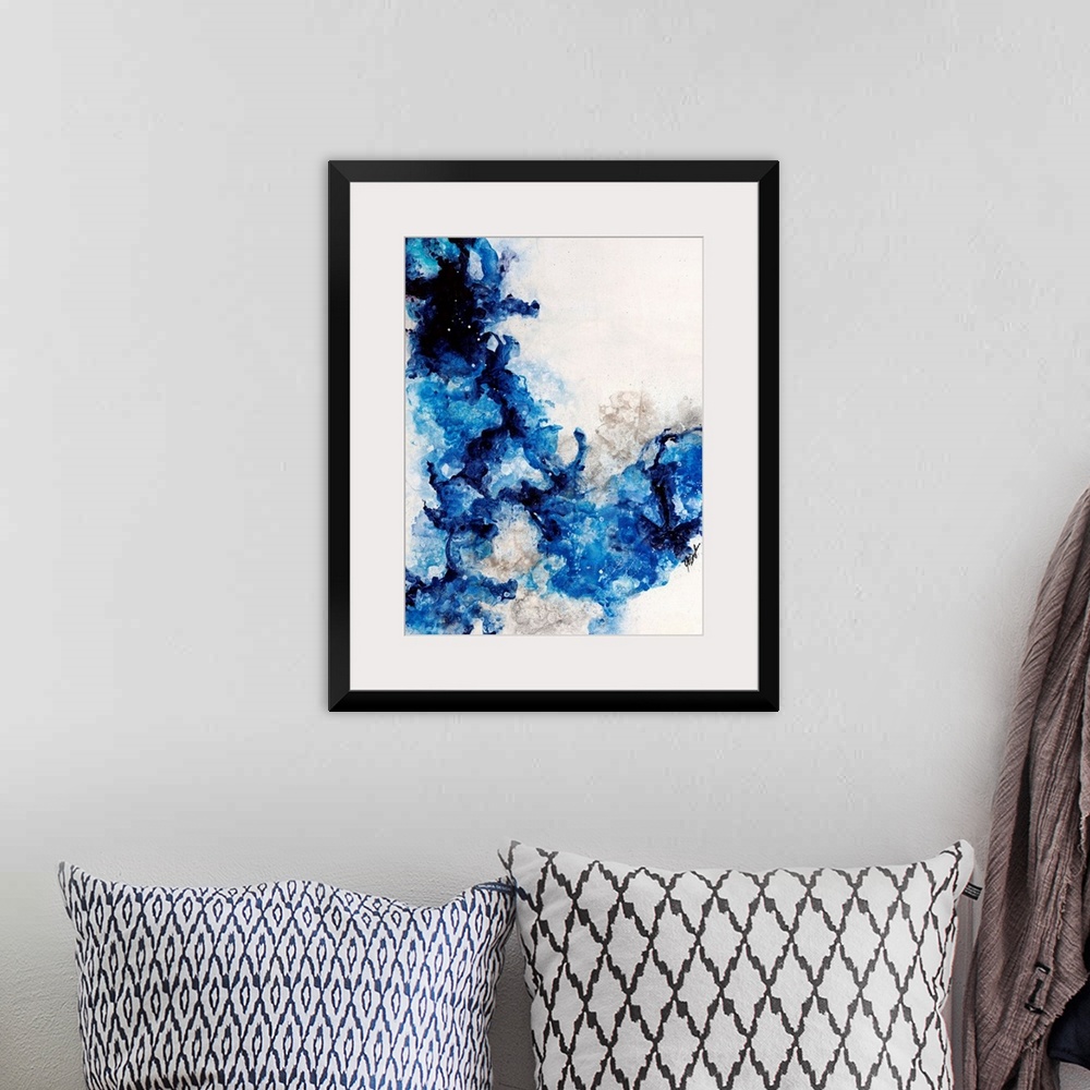 A bohemian room featuring Abstract painting of a mixture of varying blue tones swirling around against a neutral background.