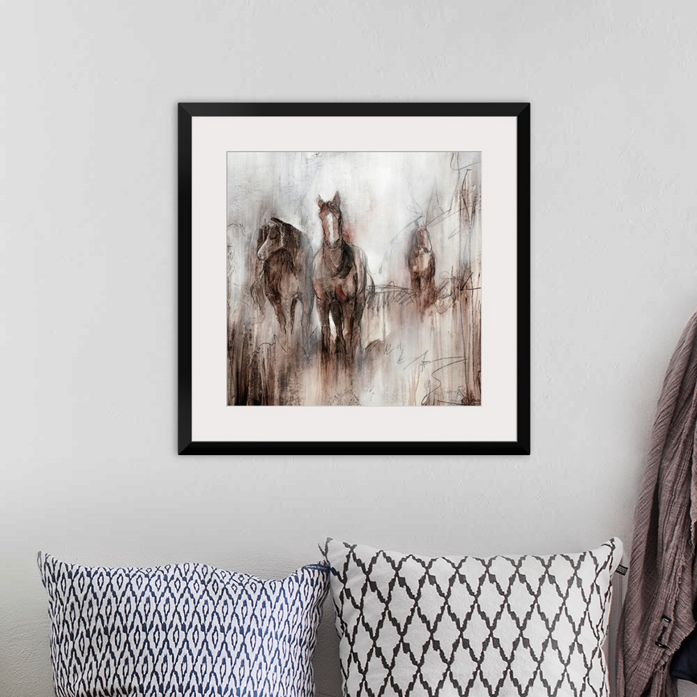 A bohemian room featuring Artwork of three horses grazing together in a field of brown on an early foggy morning.