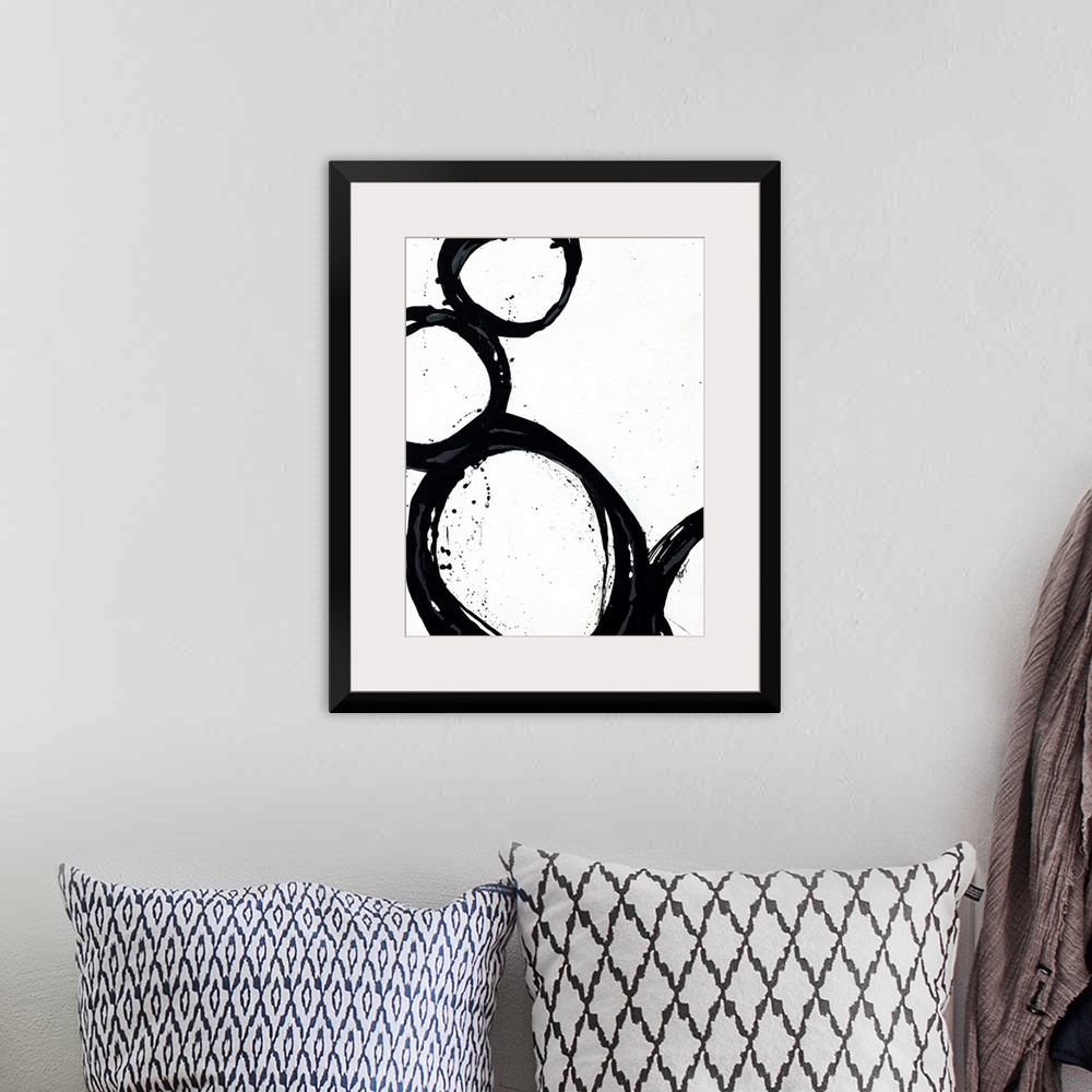 A bohemian room featuring Large abstract art includes four circles with thick borders as they sit against and on top of eac...