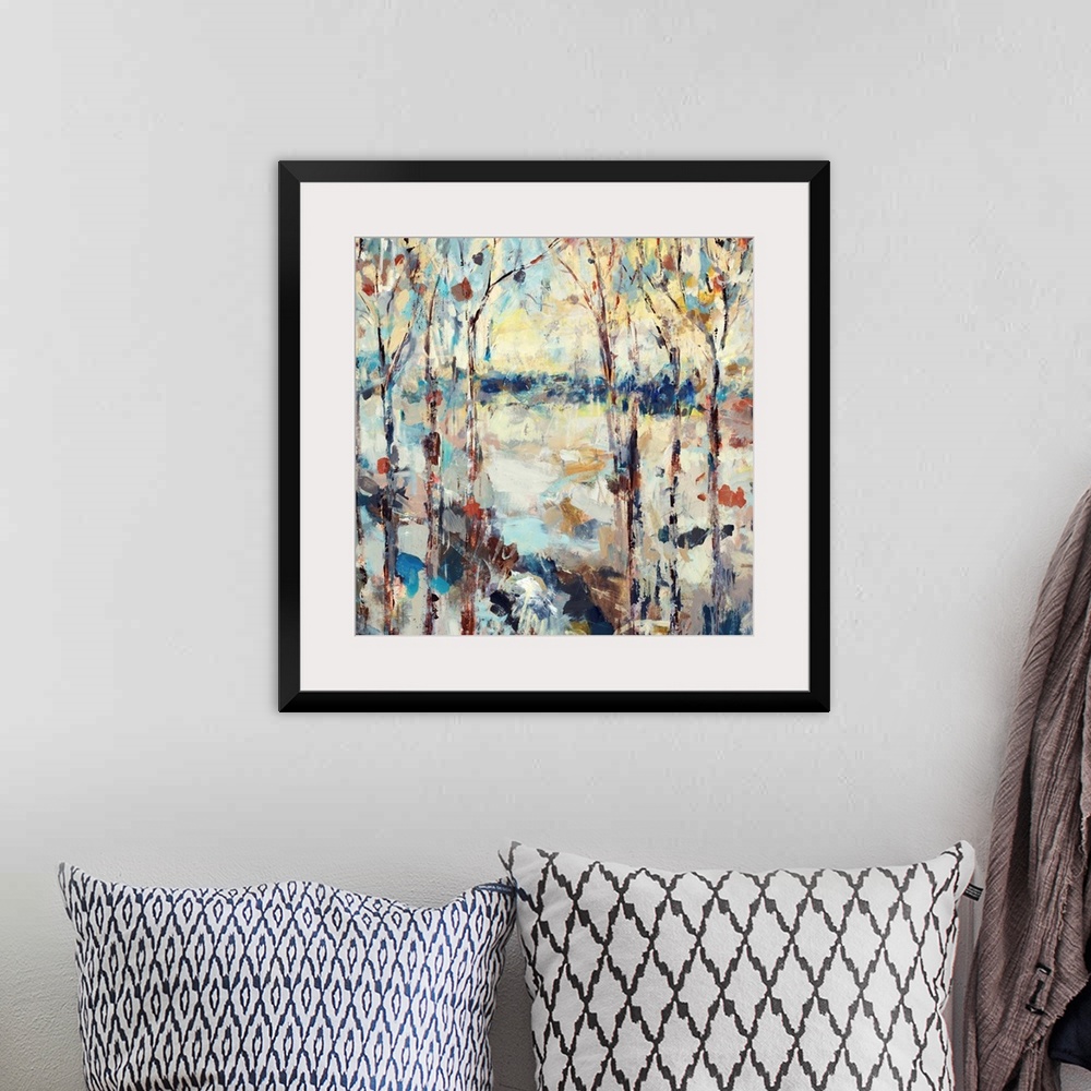 A bohemian room featuring A dramatic abstract painting of a path through a forest on square shaped wall art.