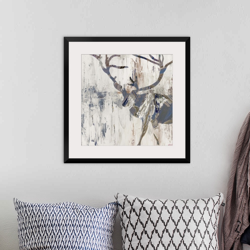 A bohemian room featuring Silhouette of a deer with large antlers in earth tones.