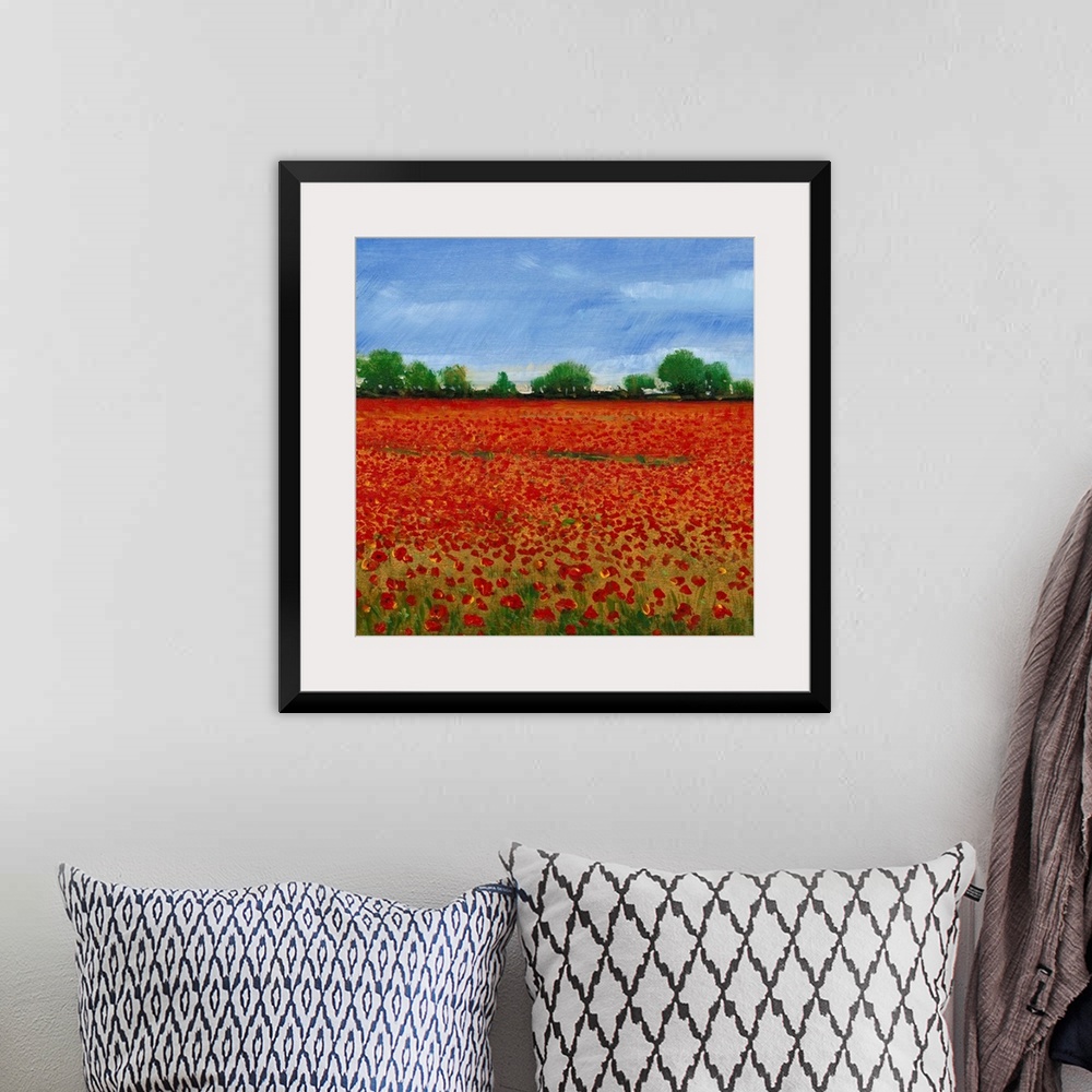 A bohemian room featuring Contemporary painting of a field of red poppies under a blue sky.