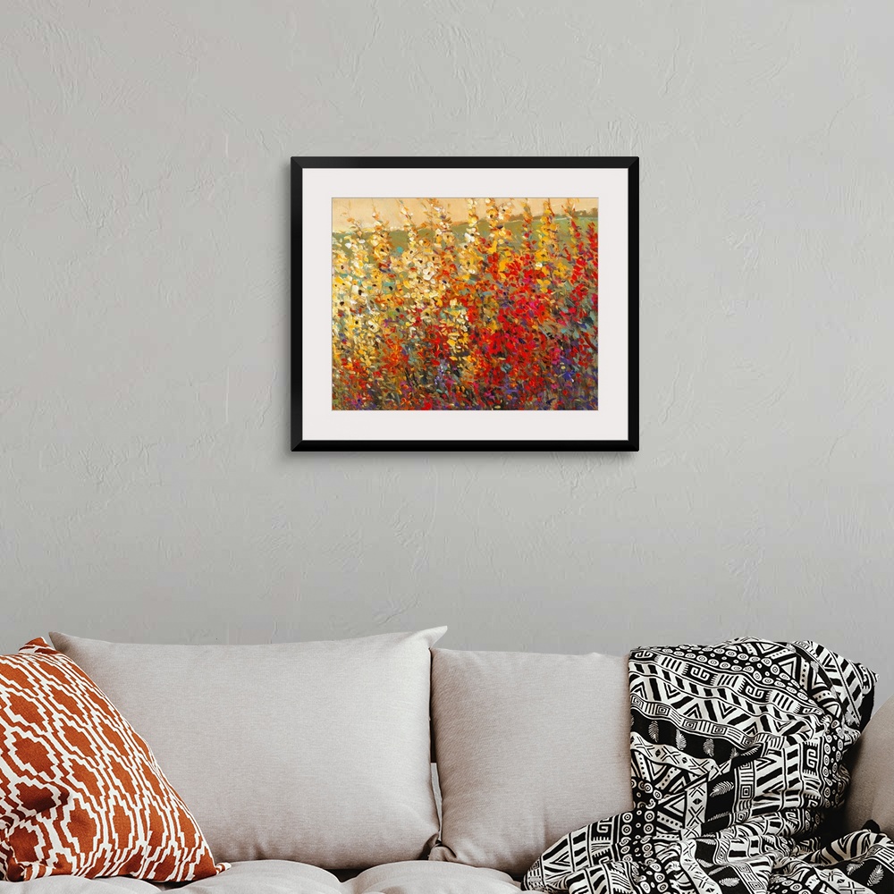 A bohemian room featuring A glorious tangle of wildflowers in warm yellow and red tones. This modern painting in the impres...