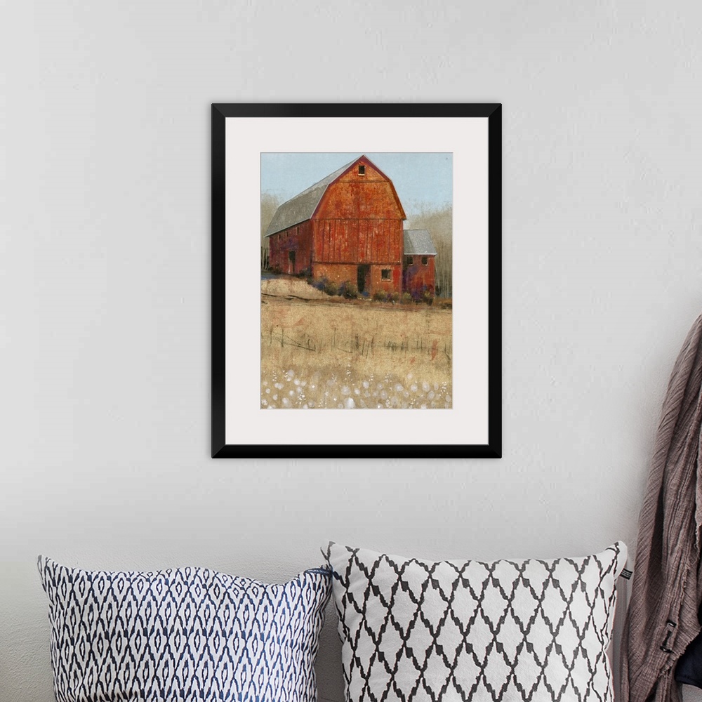 A bohemian room featuring Countryside artwork of rustic red barn on a straw colored field.