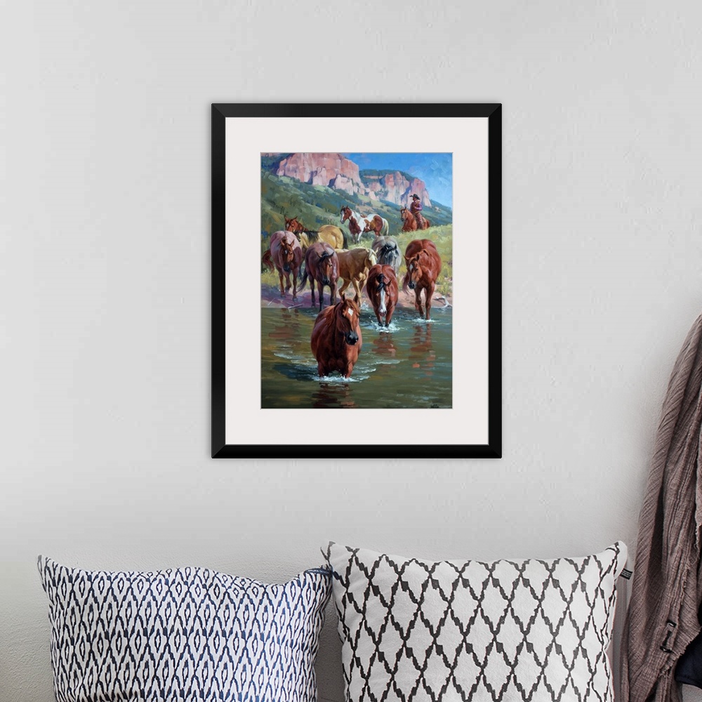 A bohemian room featuring Contemporary Western artwork of a herd of wild horses forging a river, being herded by a cowboy.