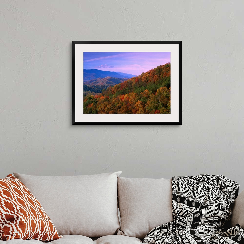 A bohemian room featuring Autumn trees cover the mountain side under a colorful twilight sky in this landscape wall art for...
