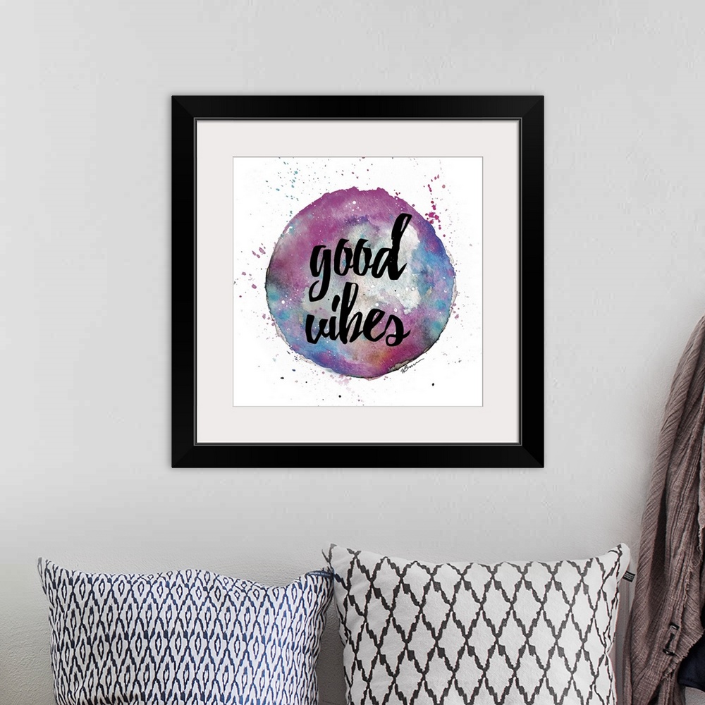A bohemian room featuring A watercolor sphere in pink and blue shades with hand-lettered text inside.