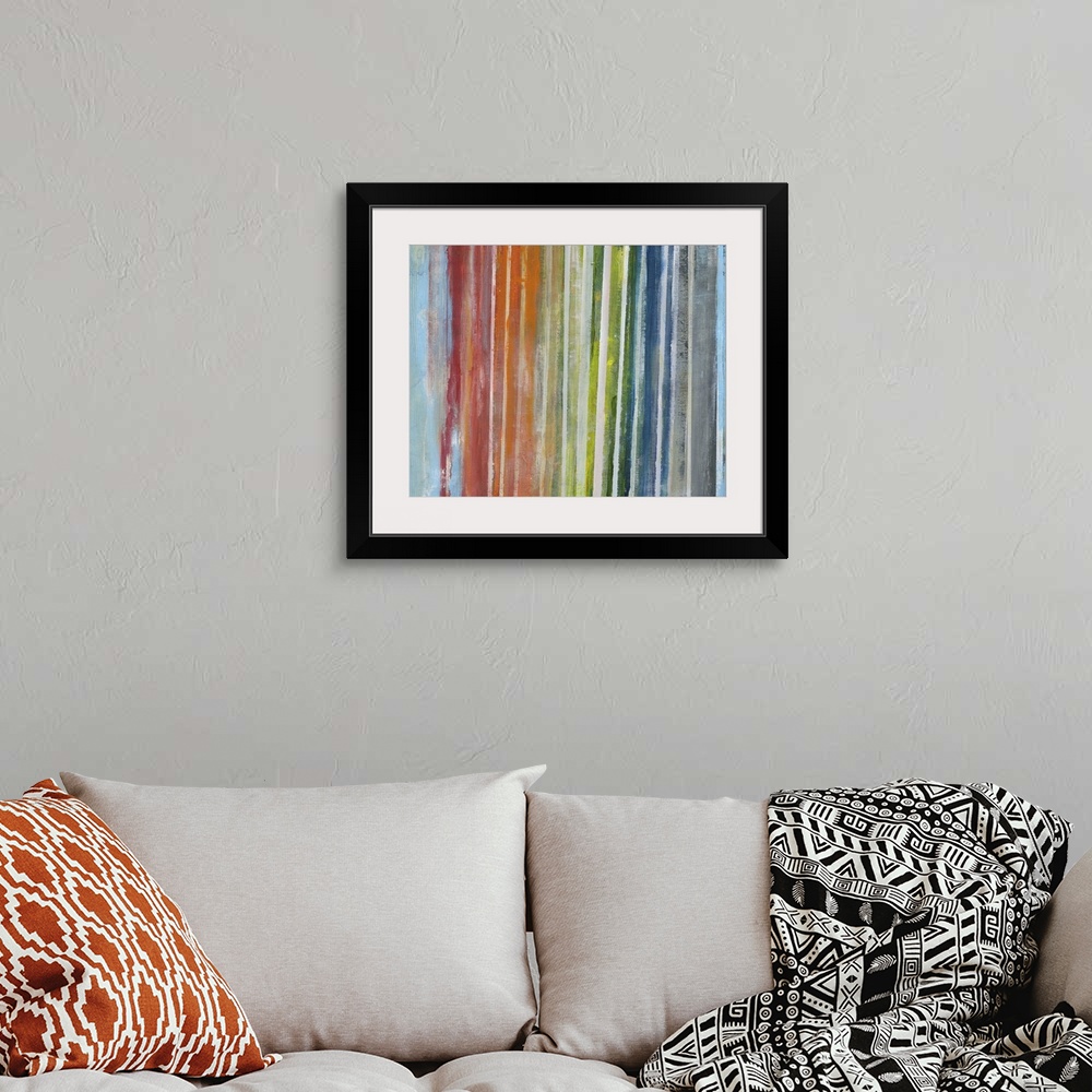 A bohemian room featuring Contemporary abstract artwork of vertical lines in a rainbow gradient.
