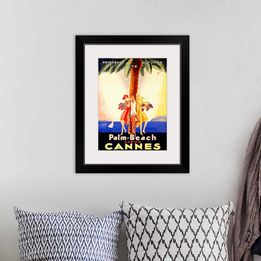 A bohemian room featuring Old stylized travel poster for a casino in France with three women leaning against a palm tree an...