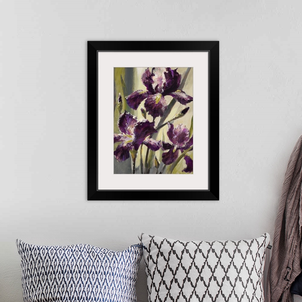 A bohemian room featuring Contemporary painting of three purple iris flowers.