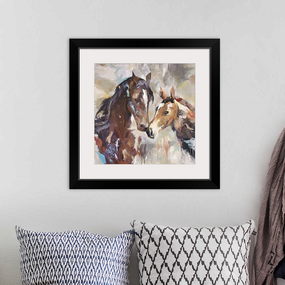 A bohemian room featuring Home decor artwork of two horses nuzzling.