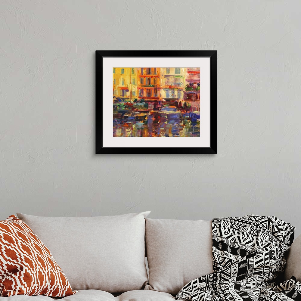 A bohemian room featuring Contemporary art painting of buildings overlooking a boat filled harbor.