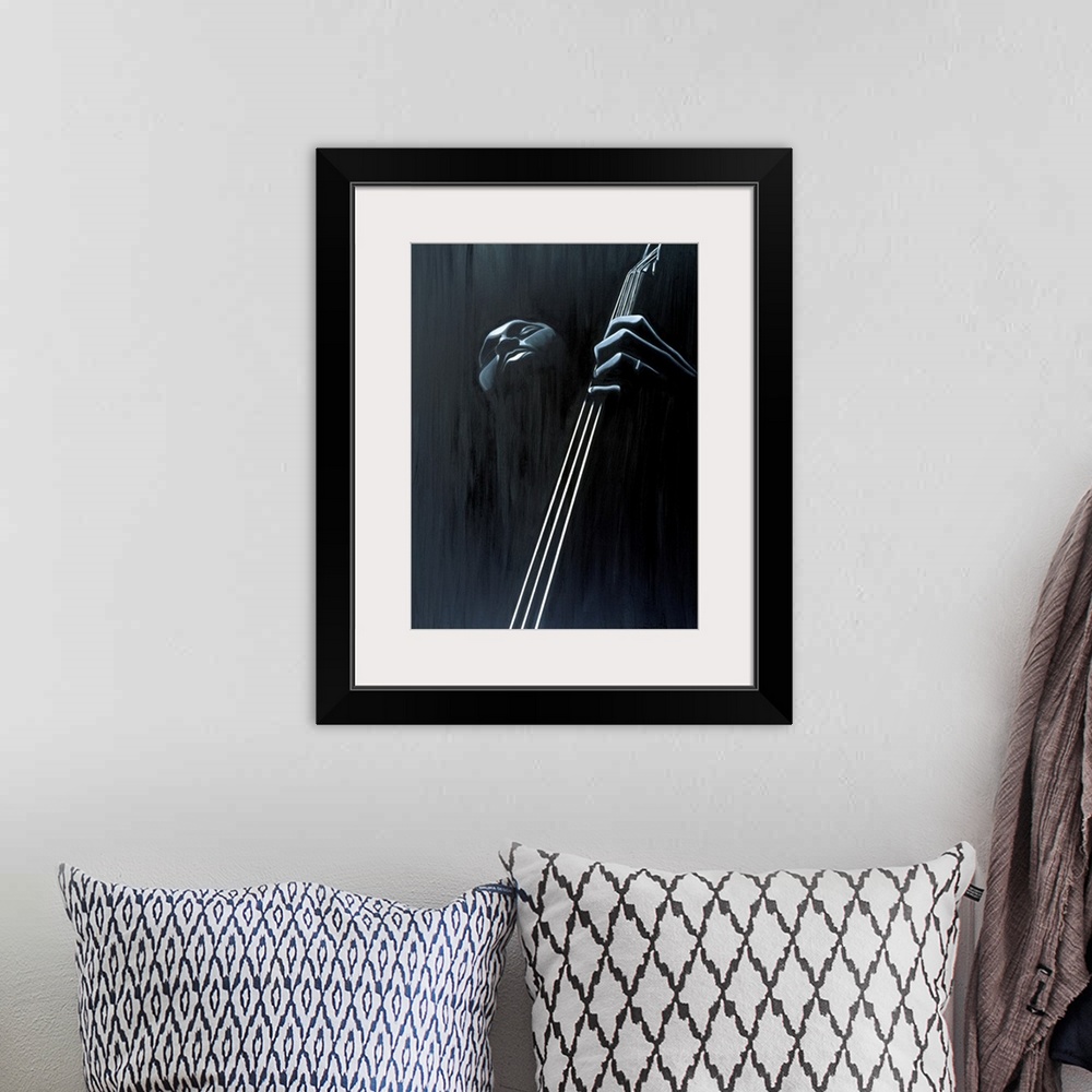 A bohemian room featuring Big contemporary monochromatic art focuses on a close-up of a man playing the bass against a slig...