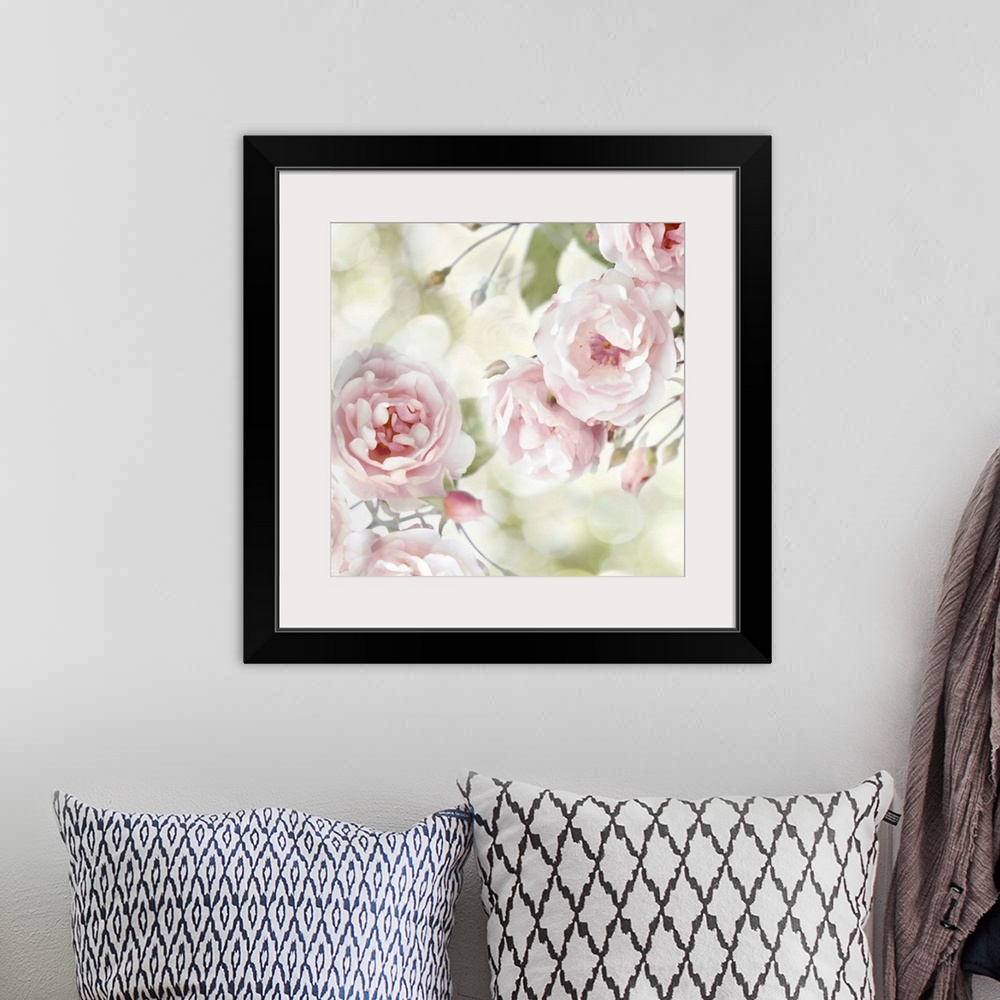 A bohemian room featuring Decorative artwork featuring soft flowers in shades of pink over a bokeh background.
