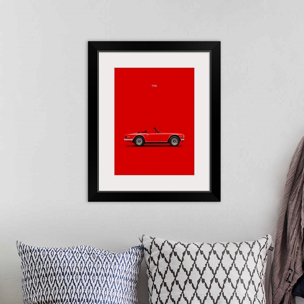 A bohemian room featuring Photograph of a red Triumph TR6 Red printed on a red background