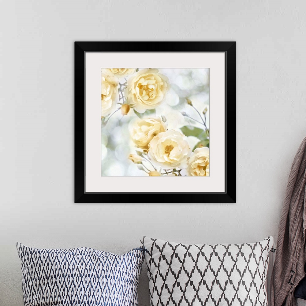A bohemian room featuring Decorative artwork featuring soft yellow flowers over a bokeh background.