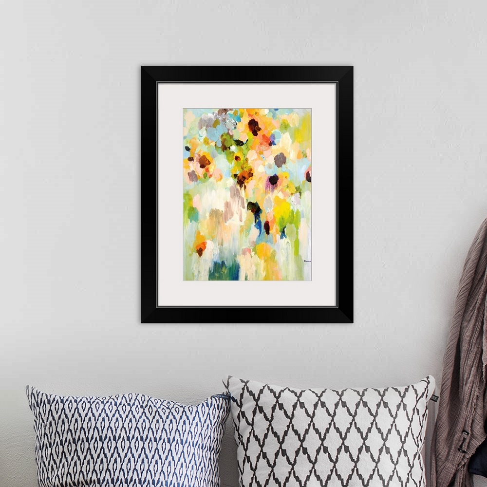 A bohemian room featuring An abstract floral painting of a large vase of bright colored flowers blending together in small ...