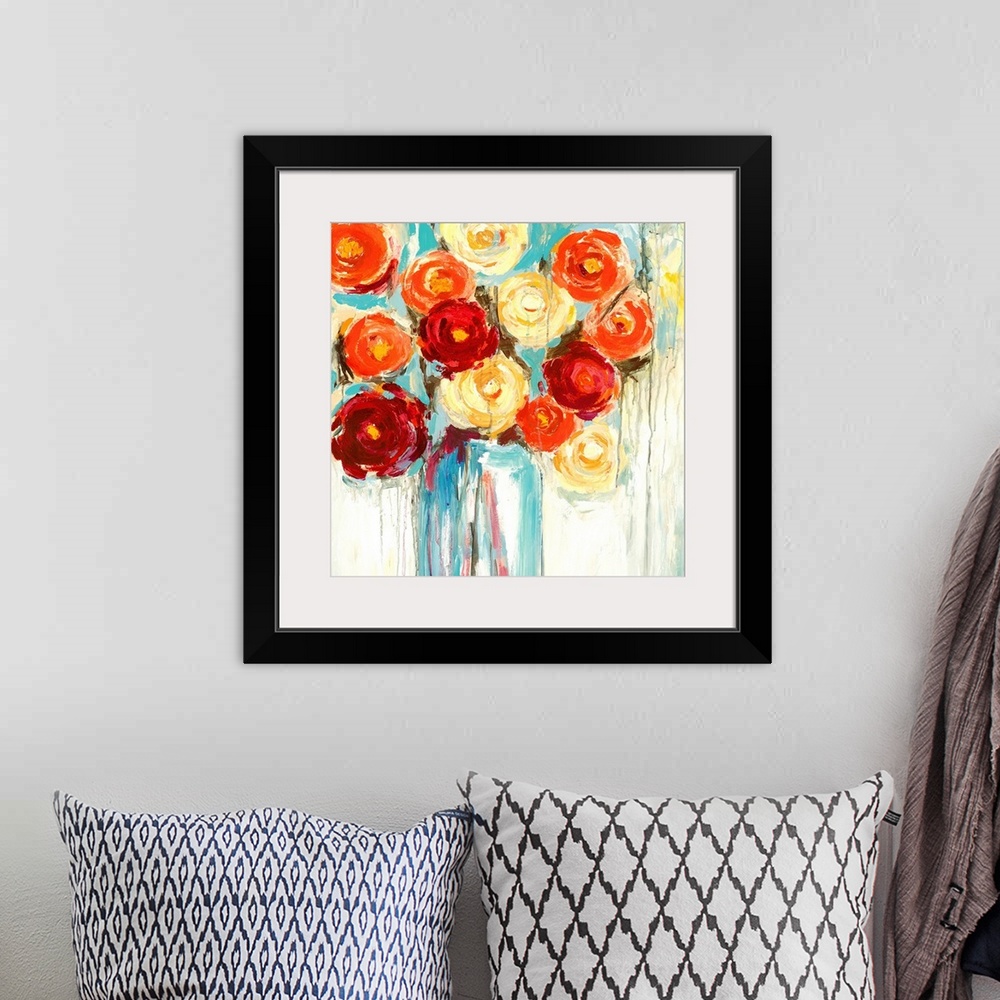 A bohemian room featuring A complementary painting of a large vase of bright orange, red and yellow flowers in textured and...