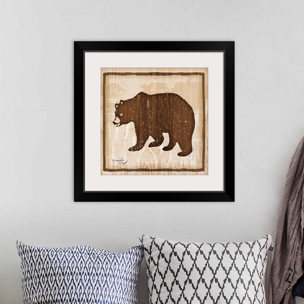 A bohemian room featuring Distressed cabin decor themed artwork of a semi-silhouetted bear against a light brown background.