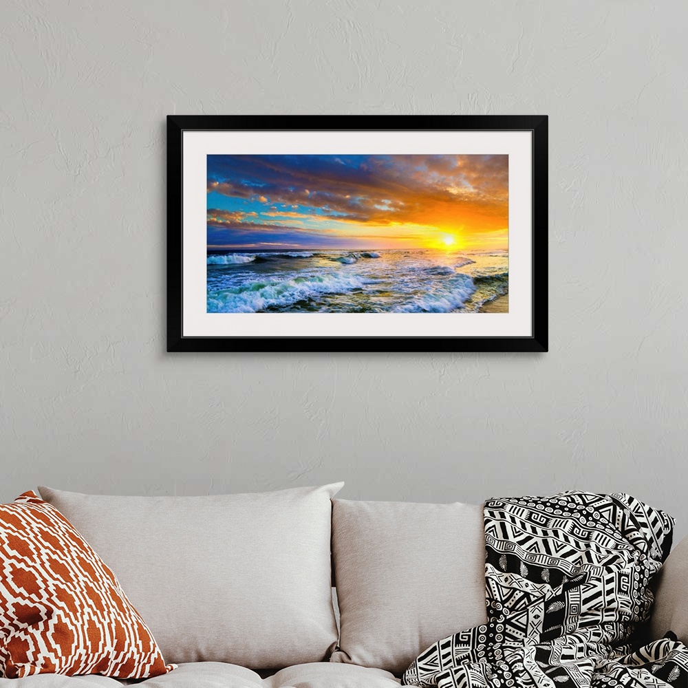 A bohemian room featuring A beautiful red sunset panorama of an ocean sunset. This landscape features a red ocean sunset wi...