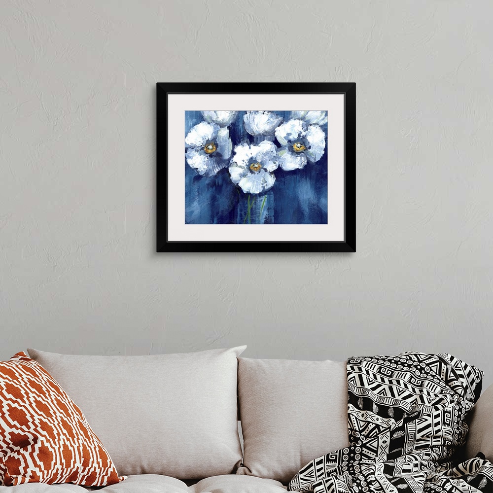 A bohemian room featuring Large painting of white poppy flowers on a dark blue background.