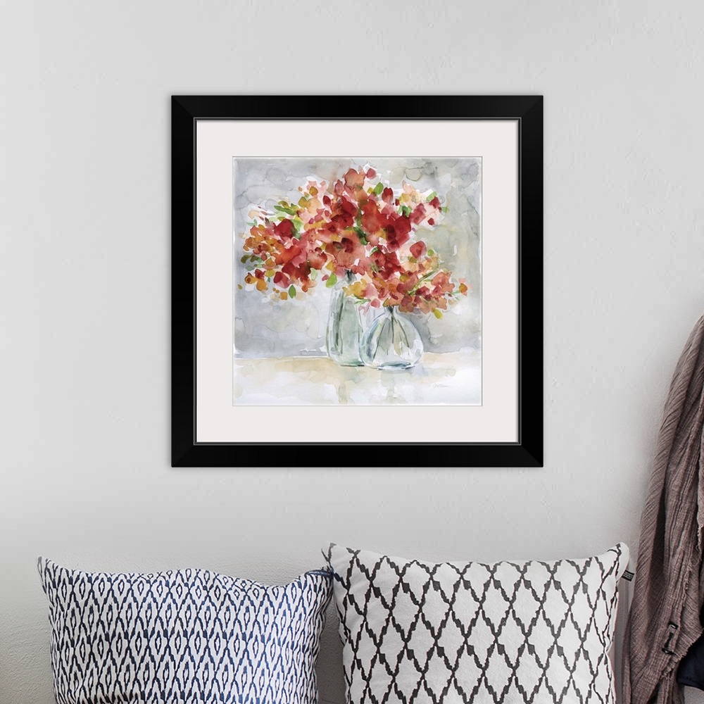 A bohemian room featuring Beautiful square watercolor painting of red and orange flowers in glass vases on a gray and tan b...