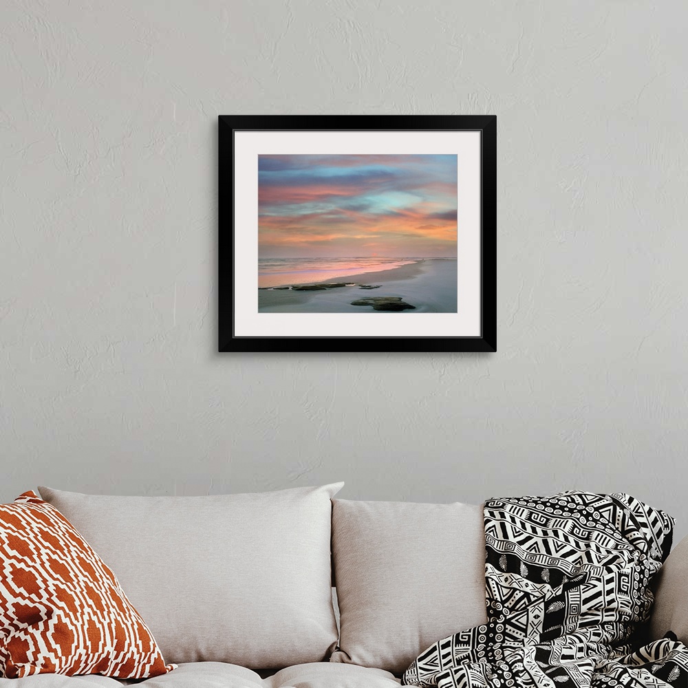 A bohemian room featuring Landscape photograph of a colorful sunset on Matanzas Beach, FL.