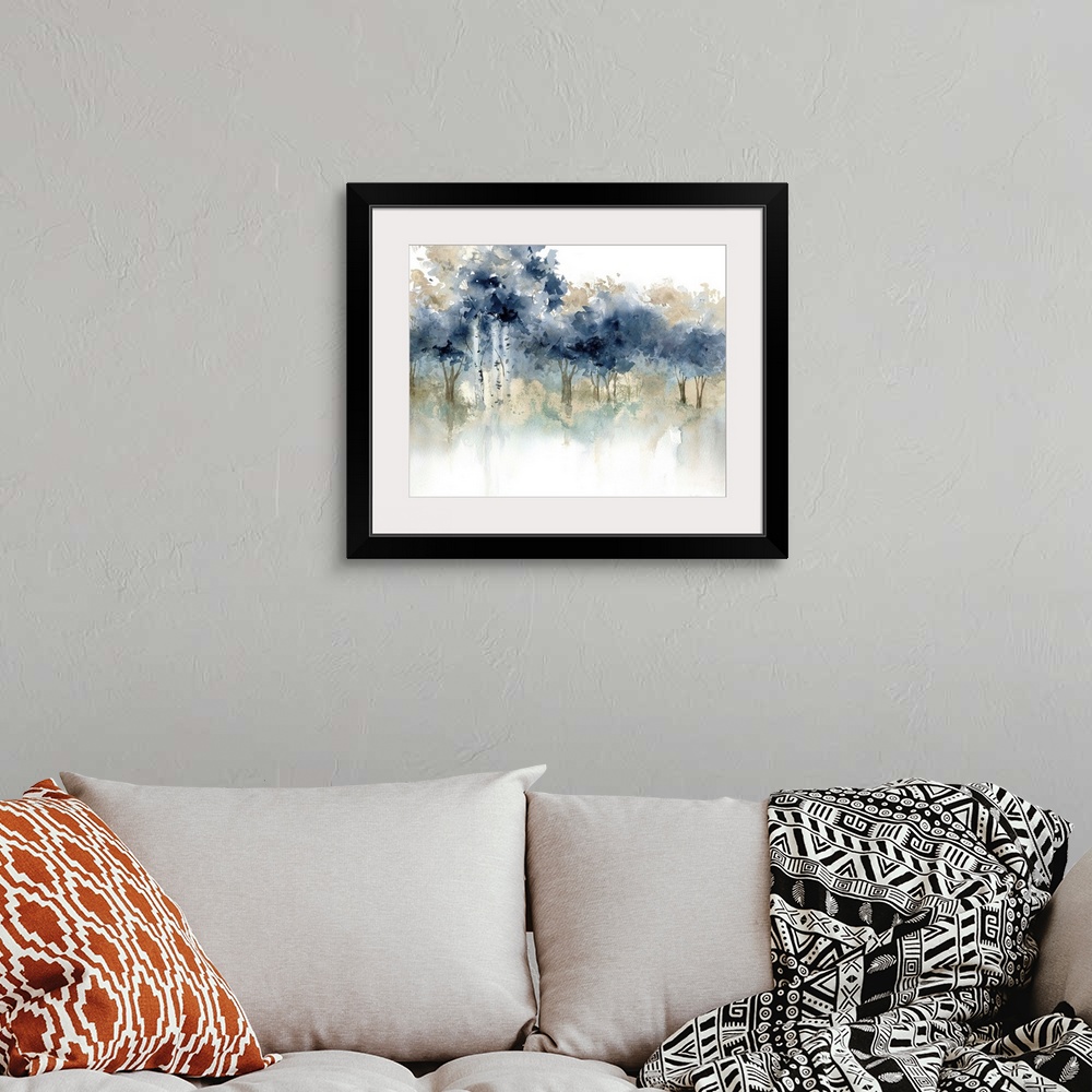 A bohemian room featuring Abstract watercolor painting of a forest filled with indigo topped trees.