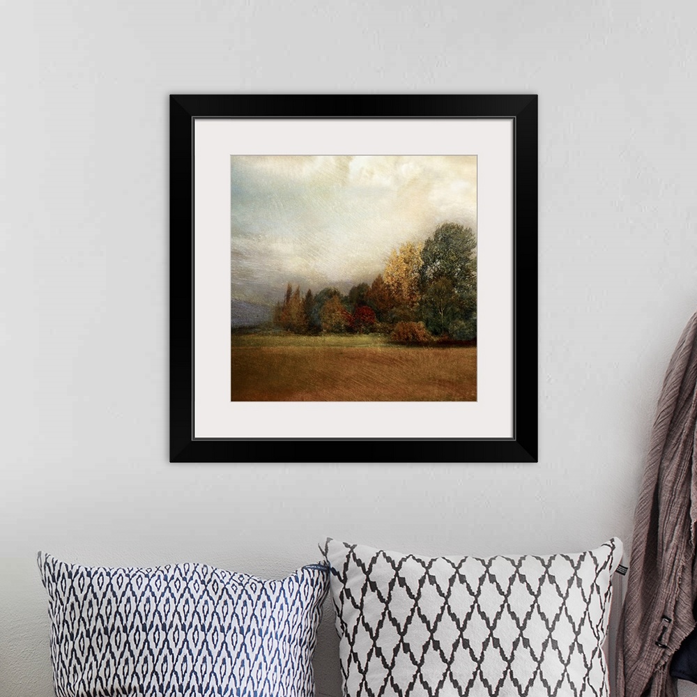 A bohemian room featuring Square panting on canvas of a field with an autumn colored forest in the background.