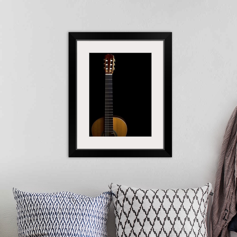 A bohemian room featuring Close-up of acoustic guitar on black