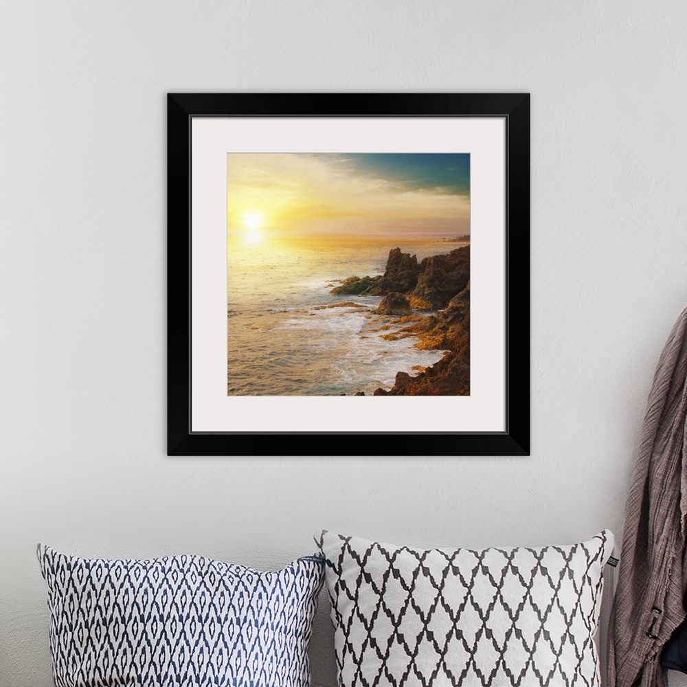 A bohemian room featuring The sun is about to set below the horizon and a photograph is taken overlooking the ocean from a ...