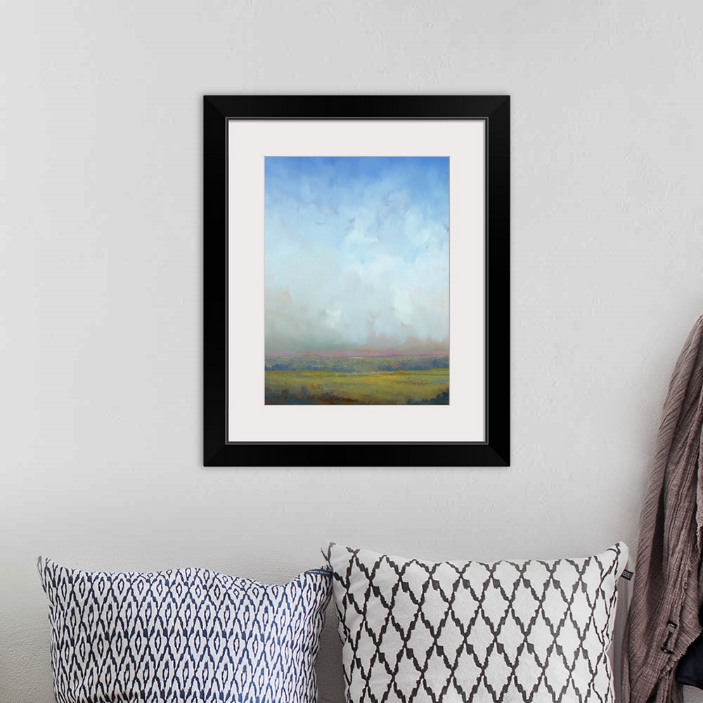 A bohemian room featuring Contemporary landscape painting of a green field with towering clouds in the sky above.