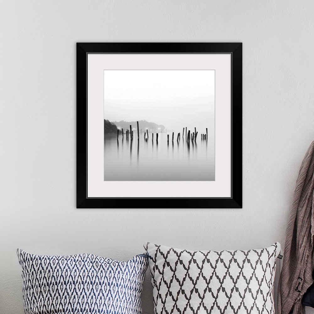 A bohemian room featuring Black and white square image of an old pier in mist.
