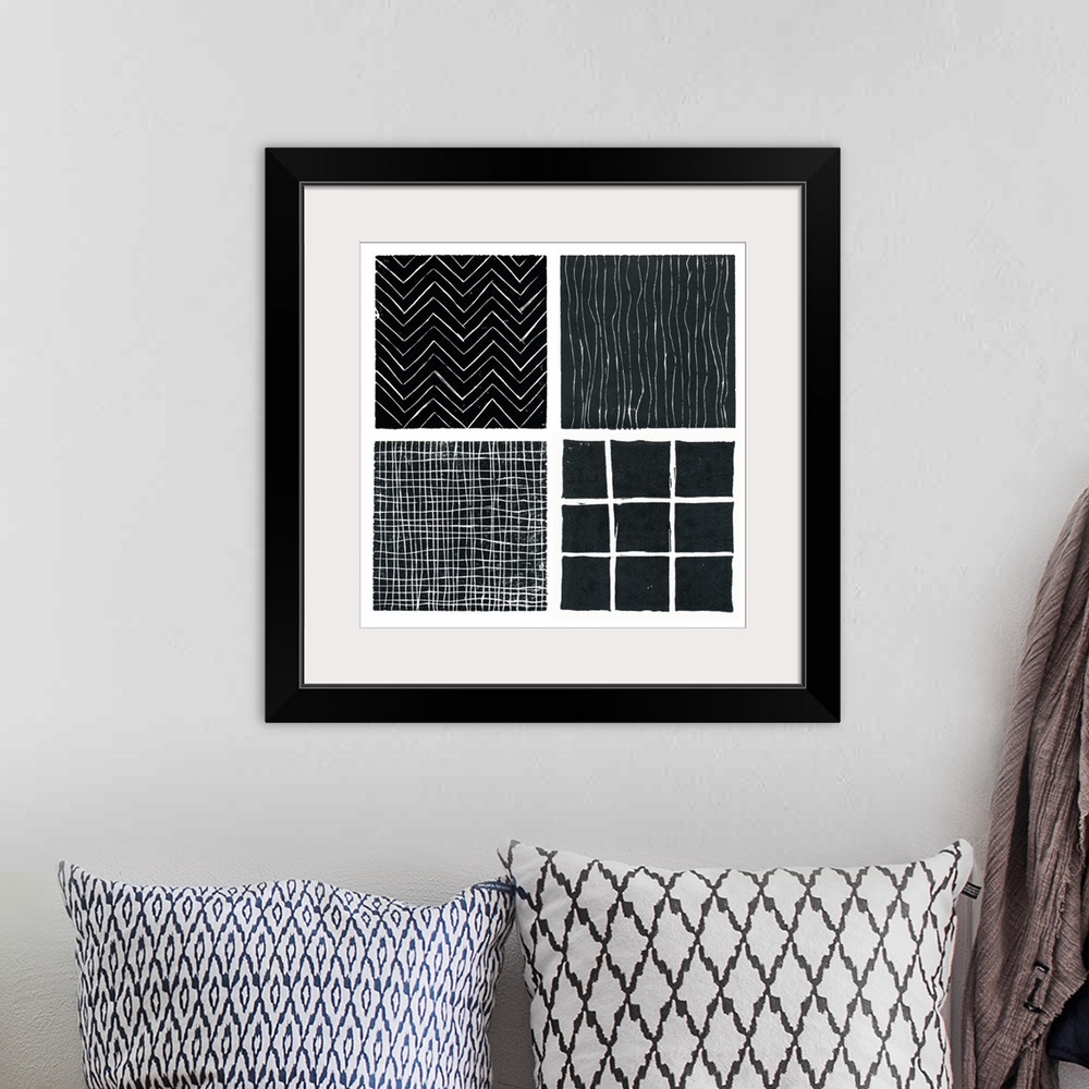 A bohemian room featuring Four b/w prints done with lino blocks and grouped as a single print.