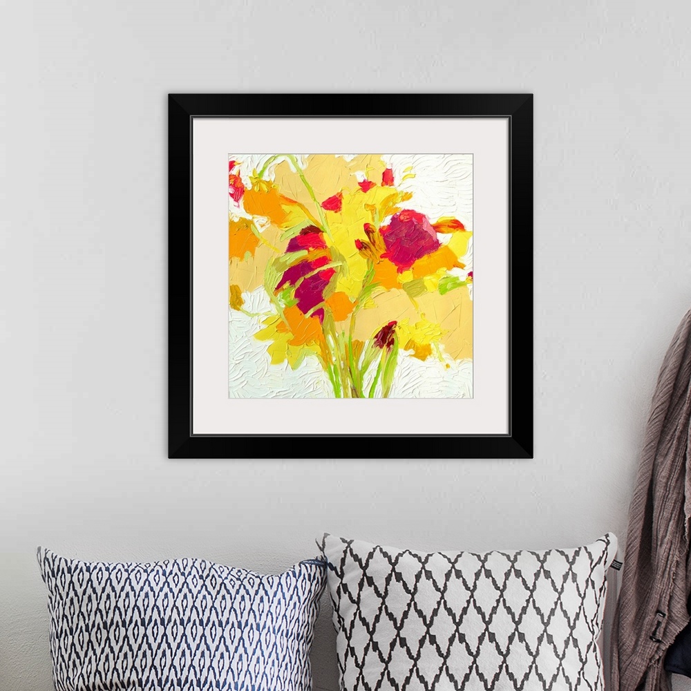 A bohemian room featuring Brightly colored contemporary artwork of a red, yellow, and orange flowers.