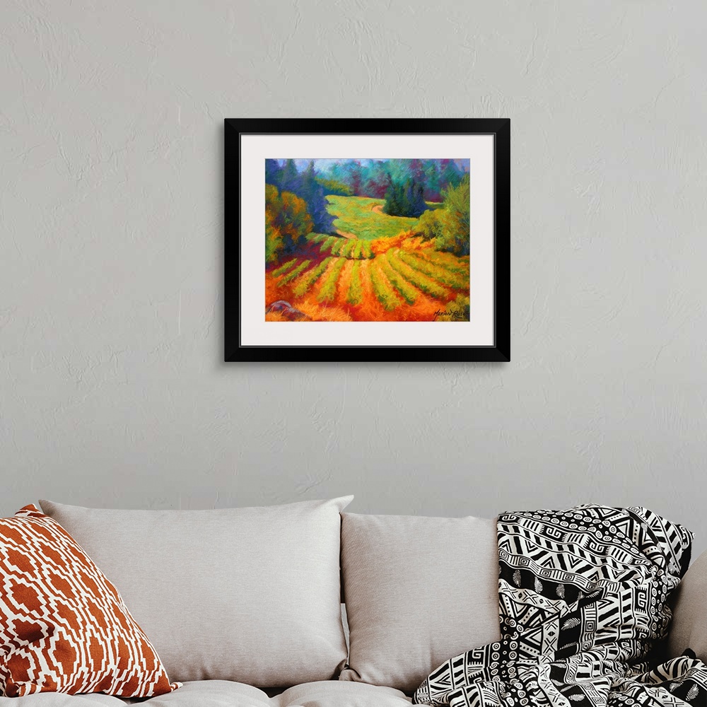 A bohemian room featuring Big painting on canvas of a  vineyard with a forest and rolling hills in the background.