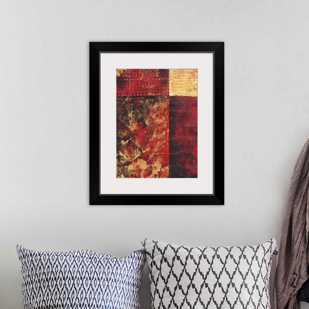 A bohemian room featuring Contemporary abstract painting using gold and red tones in geometric forms.