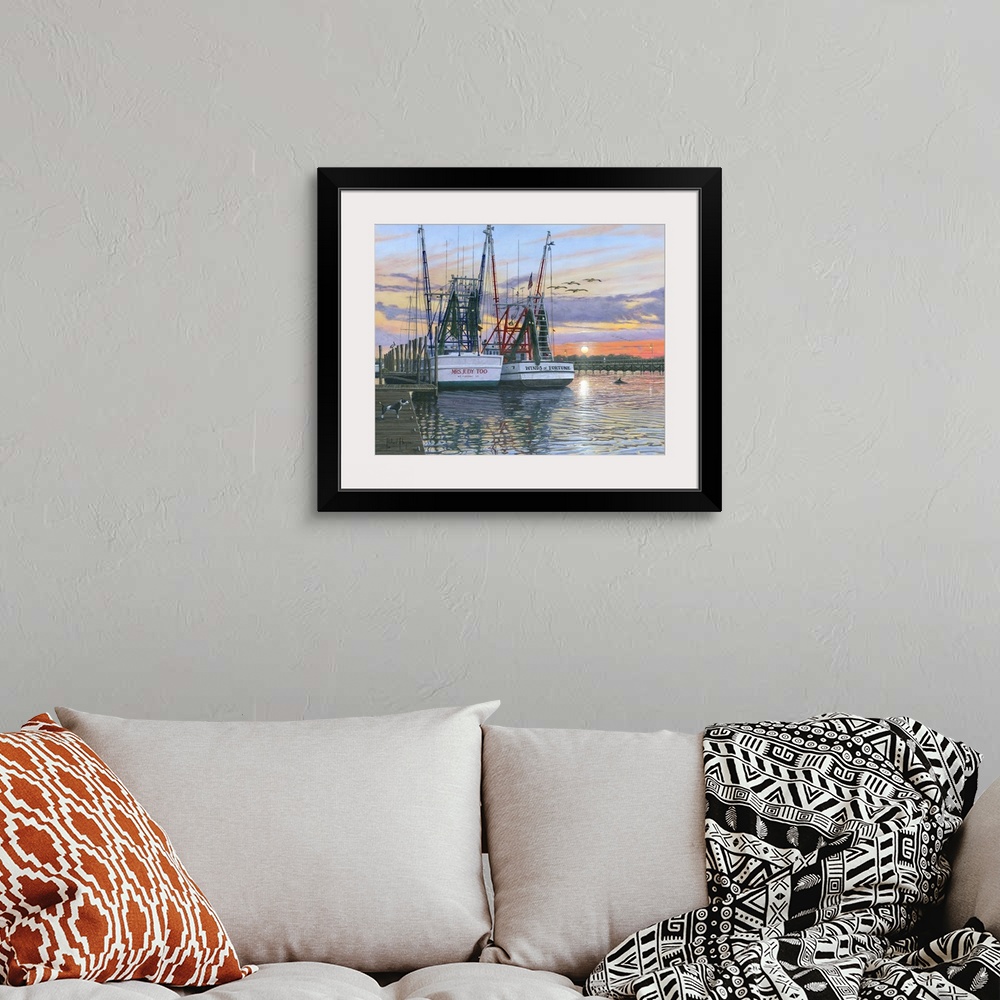 A bohemian room featuring Contemporary artwork of two fishing oats sitting in a harbor at sunset.