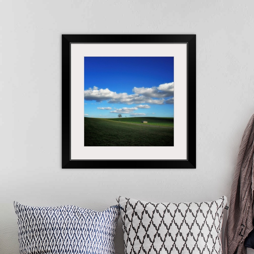 A bohemian room featuring Countryside landscape with blue sky and clouds