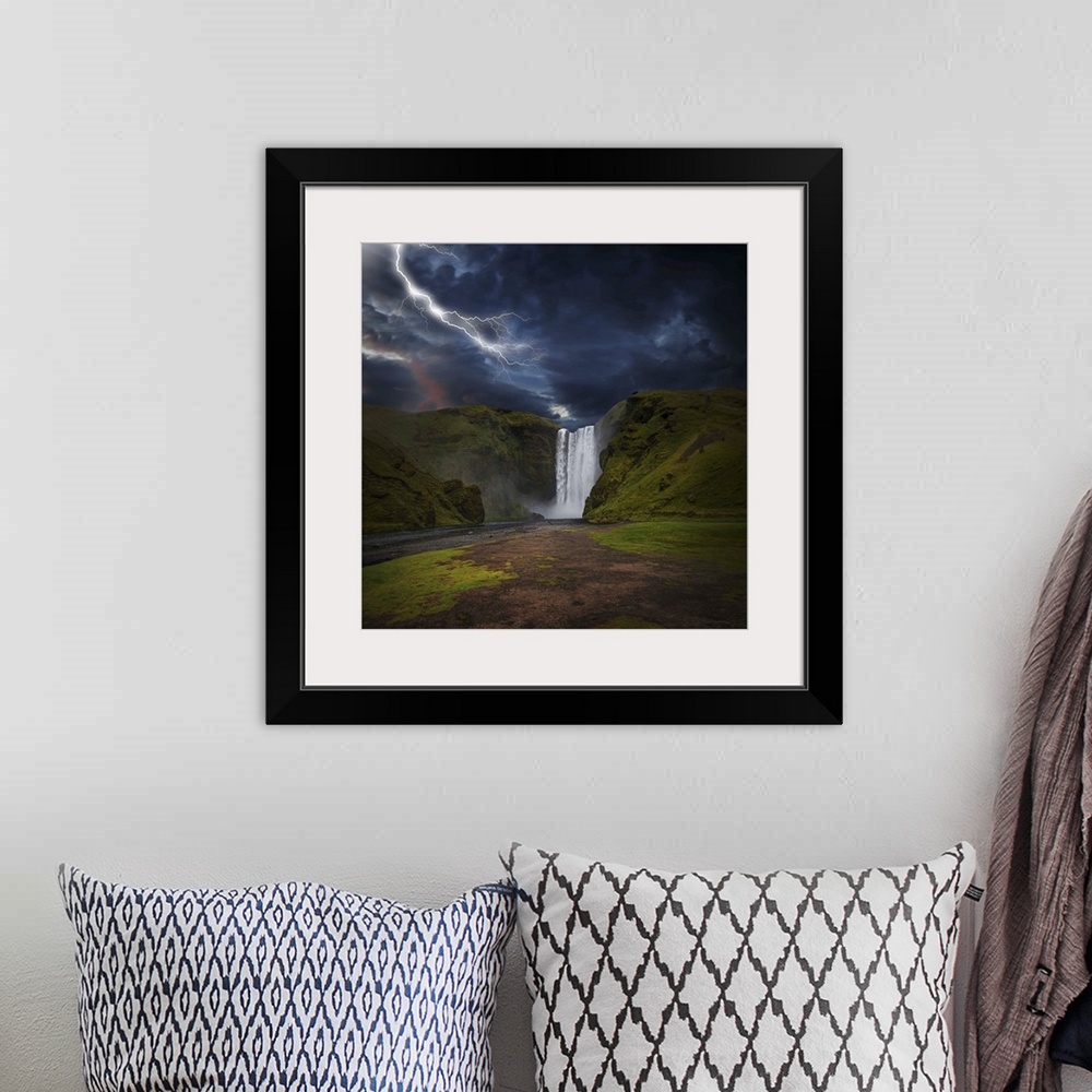 A bohemian room featuring A photograph of lightning striking over a landscape with a waterfall in the distance.