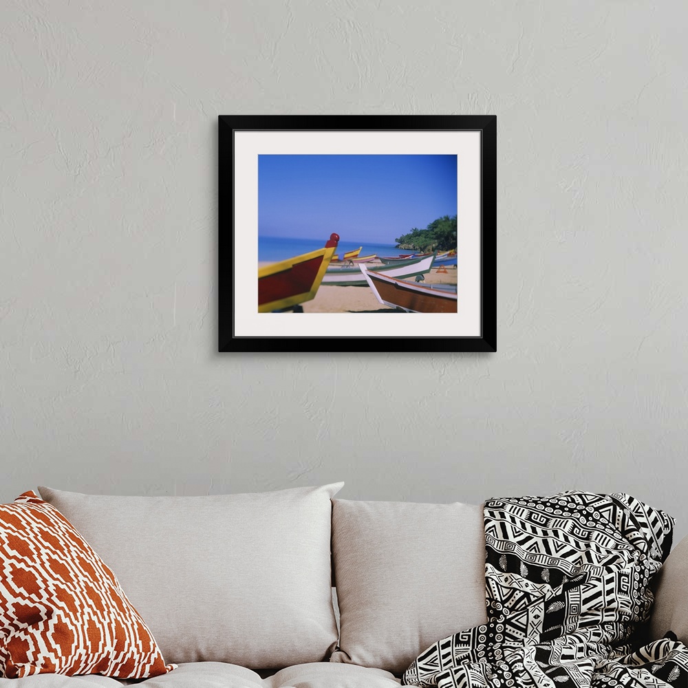 A bohemian room featuring Big canvas photo of colorful wooden boats sitting on a beach with an ocean in the background.