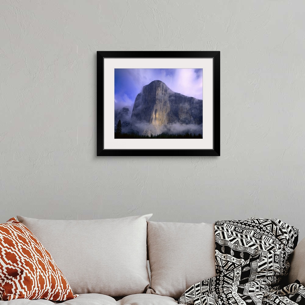 A bohemian room featuring Large photo on canvas of a mountain in Yosemite bathed in fog with a dense forest below it.