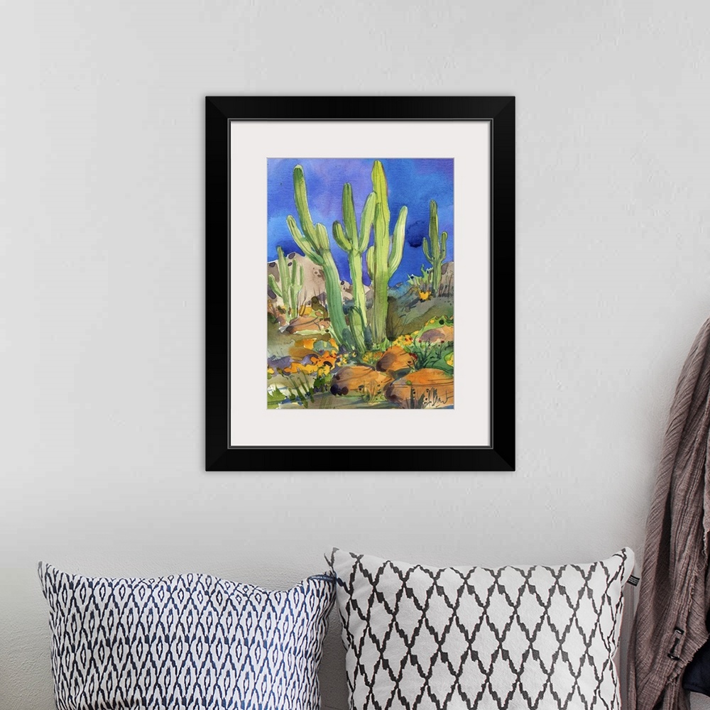 A bohemian room featuring Watercolor painting of saguaro cacti in a rocky desert.